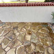 Professional-Softwashing-of-a-Stucco-Home-and-Sandstone-Walkway-Patio 1